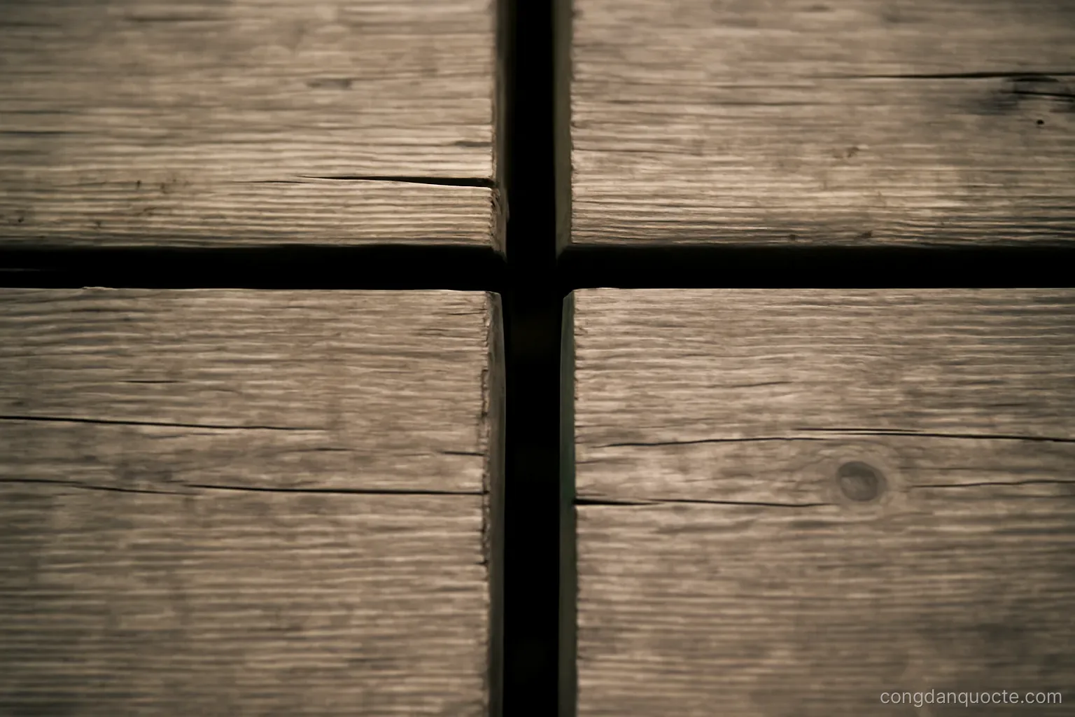 a gap between two wooden planks on a bridge walkway seen from above